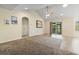 Spacious living room featuring a ceiling fan, carpet flooring, and sliding glass doors at 1133 Spalding Ct., Surfside Beach, SC 29575