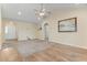 Living room boasts a mix of carpet and hardwood floors, neutral walls, and a fan at 1133 Spalding Ct., Surfside Beach, SC 29575