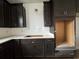 Dark kitchen cabinets, white subway tile backsplash, and white countertops at 1241 Crested Iris Way, North Myrtle Beach, SC 29582