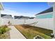 Spacious backyard with a white fence, green grass and hammock for outdoor enjoyment at 3126 White Jasmine Dr., Little River, SC 29566