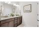 Bathroom featuring a double vanity with granite countertops and a large mirror at 3126 White Jasmine Dr., Little River, SC 29566