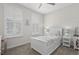 Bright bedroom with a white bed frame, plantation shutters, coastal decor, and neutral tones at 3126 White Jasmine Dr., Little River, SC 29566