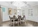 Elegant dining room featuring wainscotting, coffered ceilings, and natural light from shuttered windows at 3126 White Jasmine Dr., Little River, SC 29566