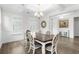 Bright dining room with a coffered ceiling, pendant lighting, and elegant dining set near shuttered windows at 3126 White Jasmine Dr., Little River, SC 29566