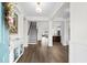 Bright foyer with hardwood floors, staircase, and open view to the modern kitchen and living spaces at 3126 White Jasmine Dr., Little River, SC 29566