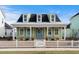 Charming home featuring a cozy front porch with rocking chairs and a beautifully landscaped yard at 3126 White Jasmine Dr., Little River, SC 29566