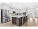 Bright kitchen features a large island with seating, stainless steel appliances, and stylish pendant lighting at 3126 White Jasmine Dr., Little River, SC 29566
