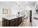 Open-concept kitchen with a central island, stainless steel dishwasher, and seamless flow to the living area at 3126 White Jasmine Dr., Little River, SC 29566