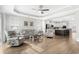 Bright, open-concept living area featuring hardwood floors, a tray ceiling, and an easy flow to the kitchen at 3126 White Jasmine Dr., Little River, SC 29566