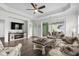 Open-concept living room with hardwood floors, tray ceiling, ample seating, and a view to the patio at 3126 White Jasmine Dr., Little River, SC 29566
