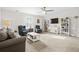 Spacious living room with comfortable seating, a ceiling fan, and built-in bookshelves with decorations at 3126 White Jasmine Dr., Little River, SC 29566
