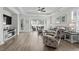 Bright living room featuring hardwood floors, tray ceiling, cozy seating, and access to the outdoor area at 3126 White Jasmine Dr., Little River, SC 29566