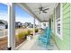 Inviting covered porch with blue rocking chairs offering a relaxing outdoor space at 3126 White Jasmine Dr., Little River, SC 29566