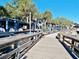Community pier with wooden walkway and blue buildings along the water at 64 Summerlight Dr., Murrells Inlet, SC 29576