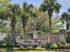 Beautiful stone sign for the Palm Bay community amidst lush landscaping at 64 Summerlight Dr., Murrells Inlet, SC 29576