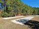 Outdoor horseshoe pits surrounded by green grass and tall trees at 64 Summerlight Dr., Murrells Inlet, SC 29576