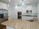 Modern kitchen featuring granite countertops, stainless steel appliances, white cabinetry, and a breakfast bar at 64 Summerlight Dr., Murrells Inlet, SC 29576