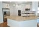 Modern kitchen featuring granite countertops, stainless steel appliances, white cabinetry, and tile backsplash at 64 Summerlight Dr., Murrells Inlet, SC 29576