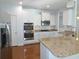 Bright kitchen featuring granite countertops, stainless steel appliances, white cabinetry, and hardwood floors at 64 Summerlight Dr., Murrells Inlet, SC 29576