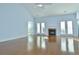 Spacious living room with vaulted ceilings, a fireplace, and double doors leading to the exterior at 64 Summerlight Dr., Murrells Inlet, SC 29576