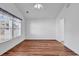 This bedroom features hardwood floors, white walls, and natural light from a window with blinds and curtains at 784 Riverward Dr., Myrtle Beach, SC 29588