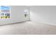 Bright bedroom with carpeted floors and two windows overlooking the backyard at 1233 Nw Calabash Station Blvd., Calabash, NC 28467
