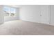 Bedroom with carpeted floors, a large window, and a convenient closet door at 1233 Nw Calabash Station Blvd., Calabash, NC 28467