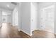 Bright hallway features beautiful hardwood flooring and neutral paint, leading to other rooms at 1233 Nw Calabash Station Blvd., Calabash, NC 28467