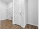 Laundry room entrance with a door leading to hardwood-style floors and wire shelving at 1233 Nw Calabash Station Blvd., Calabash, NC 28467