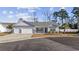 Newly built home with three-car garage and landscaped yard at 200 Obi Lane, Surfside Beach, SC 29575