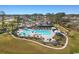 A picturesque community is displayed with a large pool, splash pad and a playground, all surrounded by lush landscaping at 3070 Sutherland Dr., Little River, SC 29566