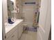 Well-lit bathroom with double sink vanity, neutral colors, and shower-tub combo at 3070 Sutherland Dr., Little River, SC 29566