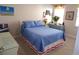 Comfortable bedroom featuring bright blue bedding and luxury vinyl plank flooring at 3070 Sutherland Dr., Little River, SC 29566
