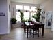Bright dining room featuring lots of light, beautiful plants and modern luxury vinyl plank flooring at 3070 Sutherland Dr., Little River, SC 29566
