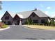 Beautiful exterior showcasing stone and composite shingle roof, complemented by a circle driveway and professional landscaping at 3070 Sutherland Dr., Little River, SC 29566