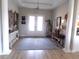 Inviting foyer featuring coastal decor, hardwood floors, and double doors at 3070 Sutherland Dr., Little River, SC 29566