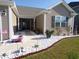 Charming home featuring a landscaped front yard with decorative rocks, flowerbeds and double-door entry at 3070 Sutherland Dr., Little River, SC 29566