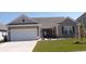 Charming single-Gathering home with a well-manicured lawn, a two-car garage, and tasteful landscaping at 3070 Sutherland Dr., Little River, SC 29566