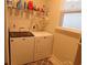 Bright laundry room featuring modern, full-size white washer and dryer for convenient chore management at 3070 Sutherland Dr., Little River, SC 29566