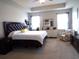 Spacious main bedroom featuring a large bed, sitting area, luxury vinyl plank flooring, and two windows at 3070 Sutherland Dr., Little River, SC 29566
