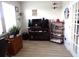 Office space with hardwood flooring, an electric fireplace, a wall of windows, and a closet at 3070 Sutherland Dr., Little River, SC 29566