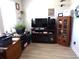 Cozy office with dark TV stand, large television and a lot of decoration pieces at 3070 Sutherland Dr., Little River, SC 29566