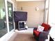 Relaxing screened-in patio featuring an outdoor beverage cooler and comfortable wicker seating for enjoying outdoor living at 3070 Sutherland Dr., Little River, SC 29566