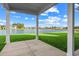 Beautiful backyard featuring a lake view, lush green grass and a covered patio great for entertaining at 377 Starlit Way, Myrtle Beach, SC 29579