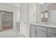 Bathroom featuring double sinks with granite countertops, tiled floors, and a walk-in closet with wire shelving at 377 Starlit Way, Myrtle Beach, SC 29579