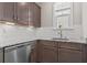 Charming kitchen featuring granite countertops, stainless steel dishwasher and undermounted sink with subway tile backsplash at 377 Starlit Way, Myrtle Beach, SC 29579
