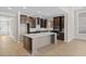 Spacious kitchen featuring hardwood floors, oversized island with a wine rack, stainless appliances and dark cabinetry at 377 Starlit Way, Myrtle Beach, SC 29579