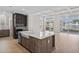Open-concept kitchen with island, stainless steel appliances, and scenic views of the lake at 377 Starlit Way, Myrtle Beach, SC 29579