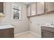 Functional laundry room with ample counter space, overhead cabinets, and modern appliances for efficient laundry tasks at 377 Starlit Way, Myrtle Beach, SC 29579