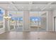 Bright living room featuring a tray ceiling and oversized windows offering beautiful views of the lake at 377 Starlit Way, Myrtle Beach, SC 29579
